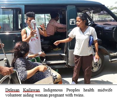 Delesan Kailawan Indigenous Peoples health midwife volunteer aiding woman pregnant with twins.